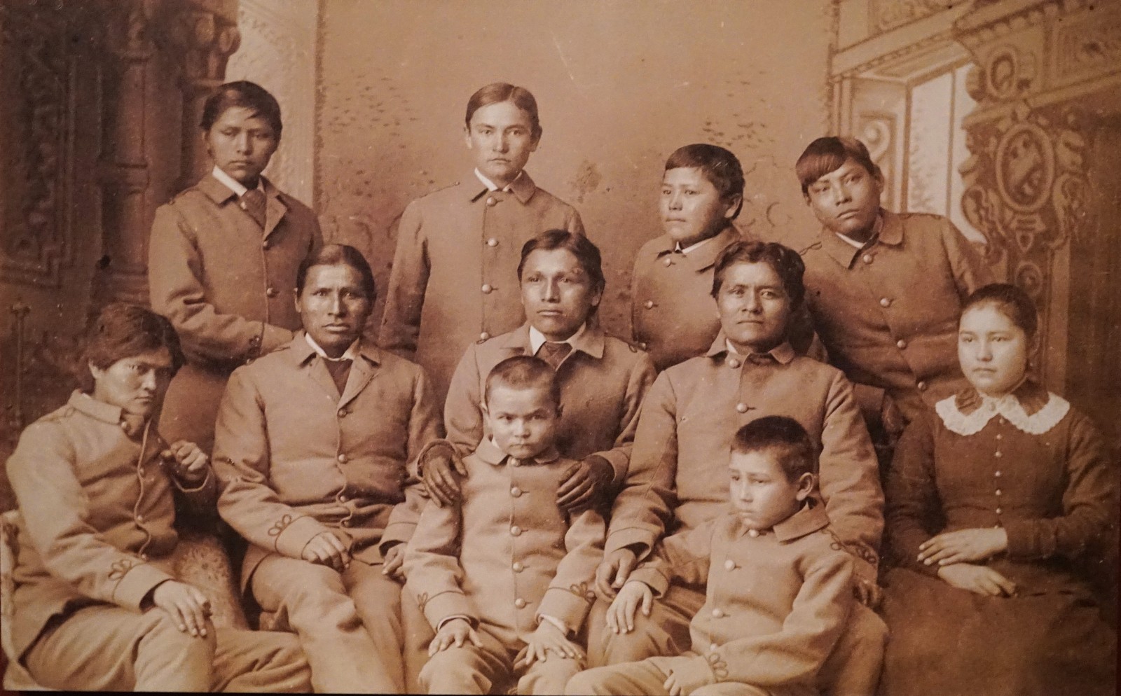 Portrait of Tom Torleno and Group of Boys in Uniform With Unidentified Girl from New Mexico, Six Months After Arrival at School.